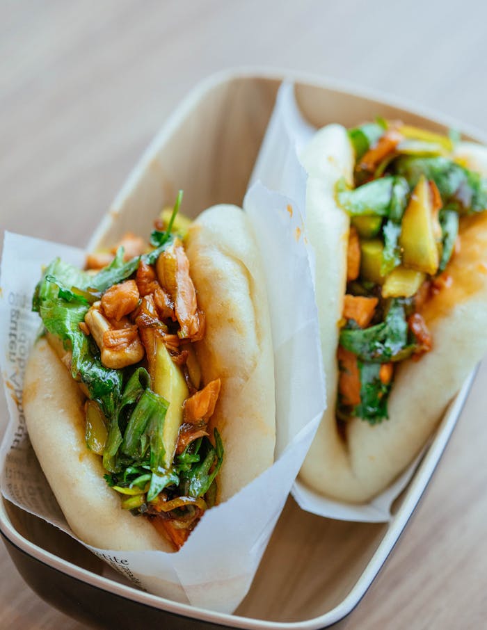Close-up of tasty vegetable bao buns with fresh ingredients and vibrant colors, perfect for a healthy meal.
